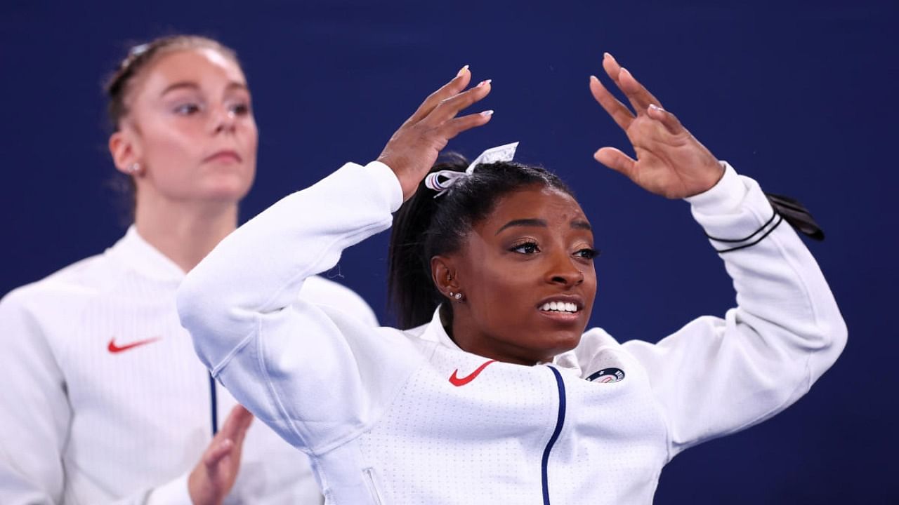 Simone Biles of the United States reacts as teammates perform. Credit: Reuters Photo