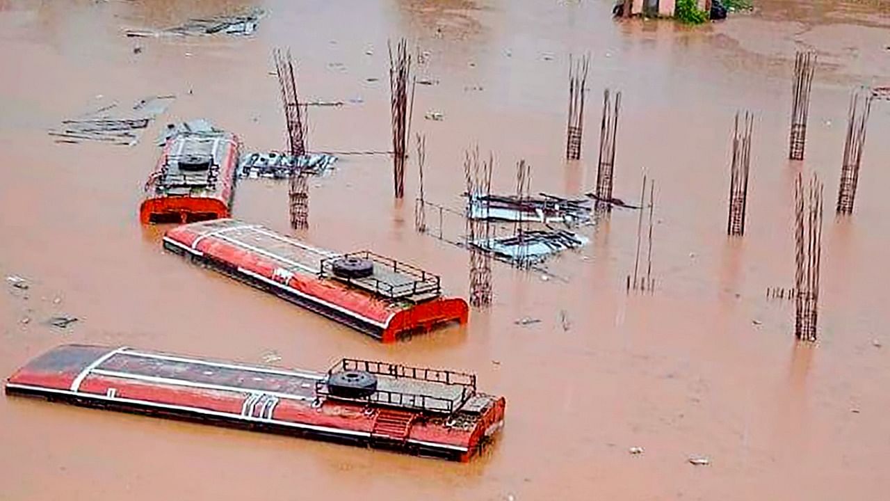 Buses submerged in a flood affected area following heavy rains, at Chiplun in Ratnagiri district, Credit: PTI File Photo