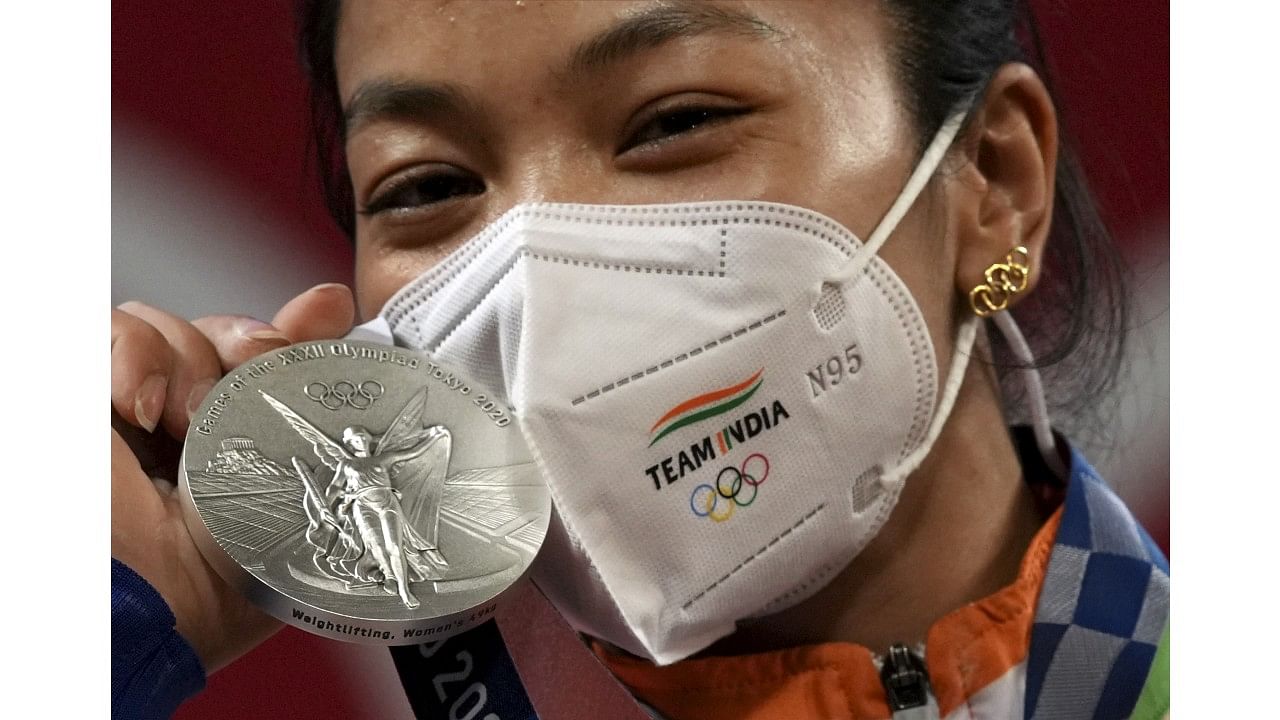 Mirabai Chanu with her silver medal. Credit: PTI Photo