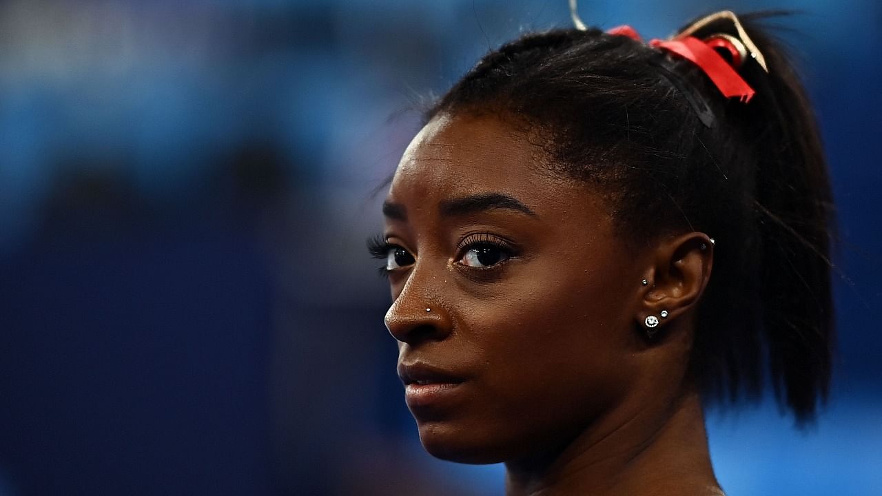 USA's Simone Biles gets ready to compete in the uneven bars event of the artistic gymnastics women's qualification during the Tokyo 2020 Olympic Games at the Ariake Gymnastics Centre in Tokyo. Credit: AFP Photo