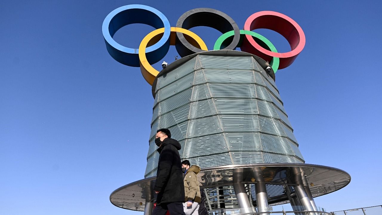 In this file photo taken on February 03, 2021 A group of people visit Beijing Olympic tower in Beijing on February 3, 2021, a year before the opening of the 2022 Winter Olympics. Credit: AFP Photo
