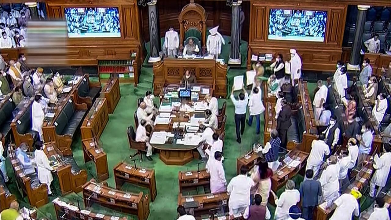 Members protest in the Lok Sabha during the Monsoon Session of Parliament, in New Delhi. Credit: PTI Photo