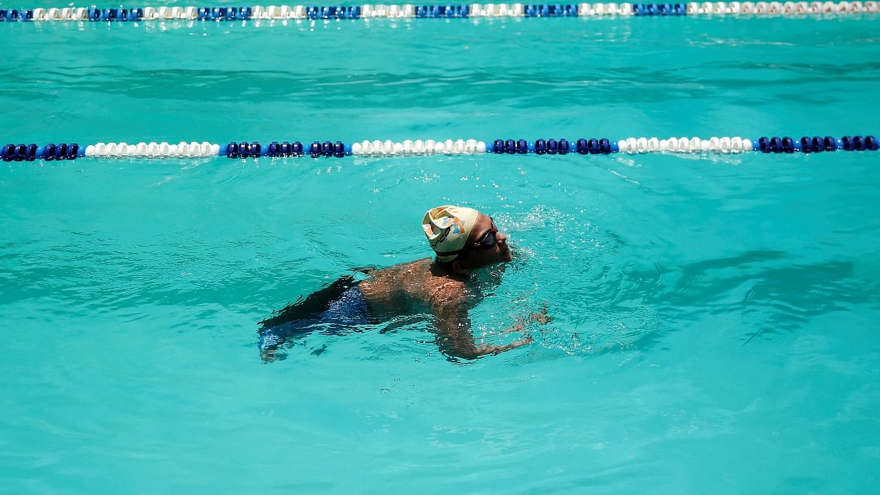 Venezuelan Paralympic swimmer Jose Gregorio Montilla floats in the pool during a training session, as he hopes to win gold in the 50-meter breaststroke at the Tokyo Paralympic Games, in Caracas. Credit: Reuters photo