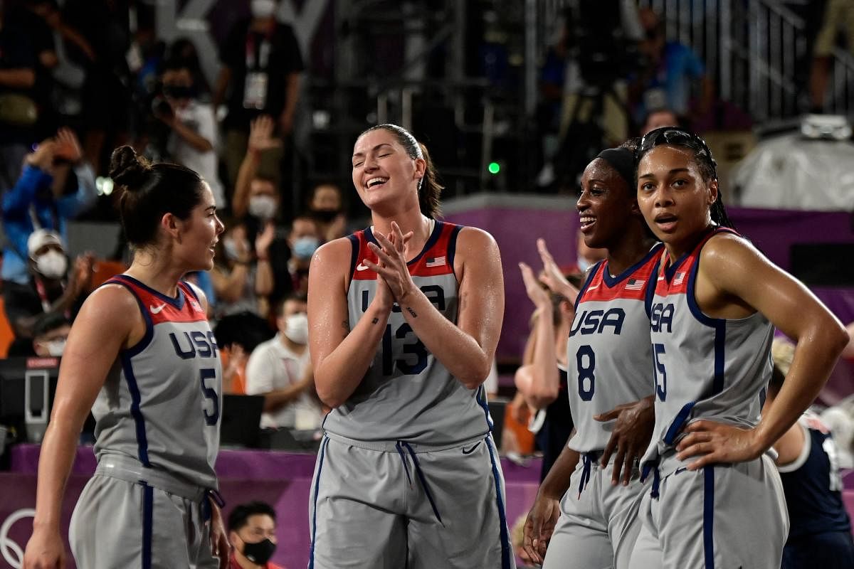 USA's teammates celebrate after wining at the end of the women's gold medal 3x3 basketball final match between US and Russia at the Aomi Urban Sports Park in Tokyo. Credit: AFP Photo