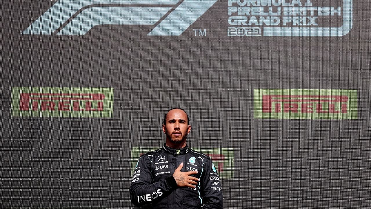 Mercedes' Lewis Hamilton celebrates on the podium. Credit: Reuters Photo