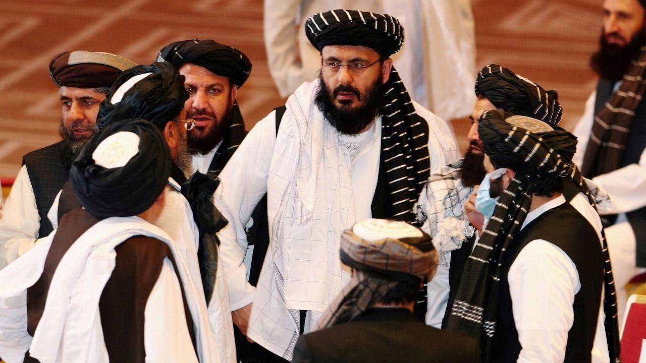 Taliban delegates speak during talks in Doha. Credit: Reuters Photo