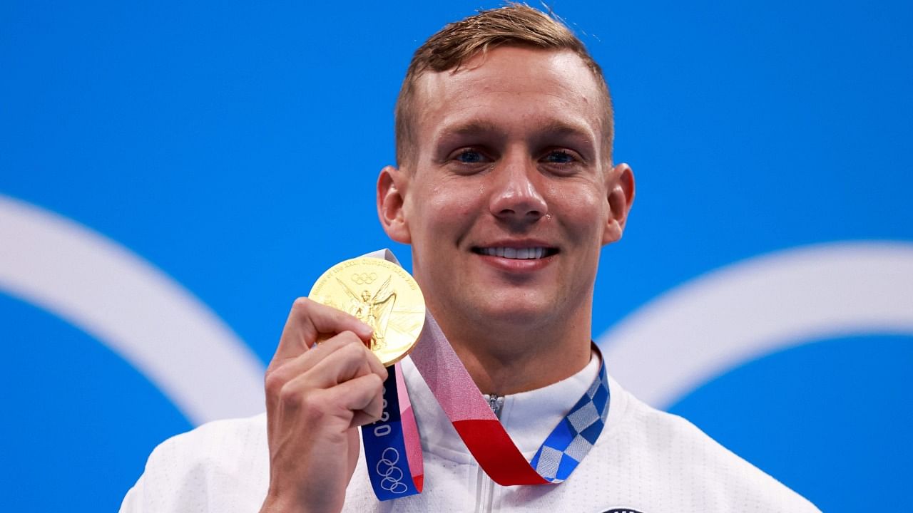 USA's Caeleb Dressel poses with their gold medal after the final of the men's 100m freestyle swimming event. Credit: AFP Photo