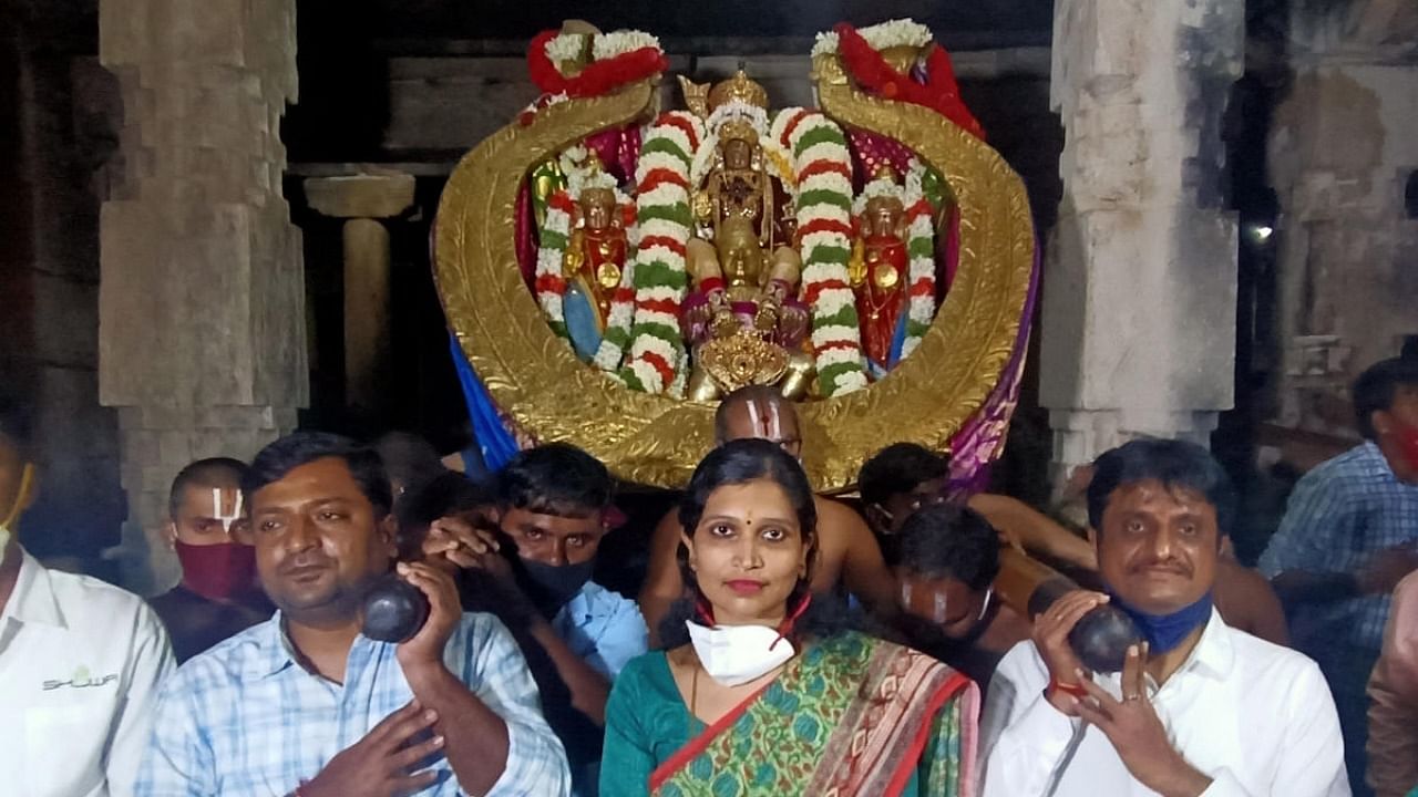 The procession idol of Chaluvarayaswamy adorned with diamond studded crown is taken out within the temple premises as part of Krishnarajamudi Utsava at Melkote in Mandya district on Thursday. Deputy Commissioner S Aswathi is also seen. Credit: DH photo