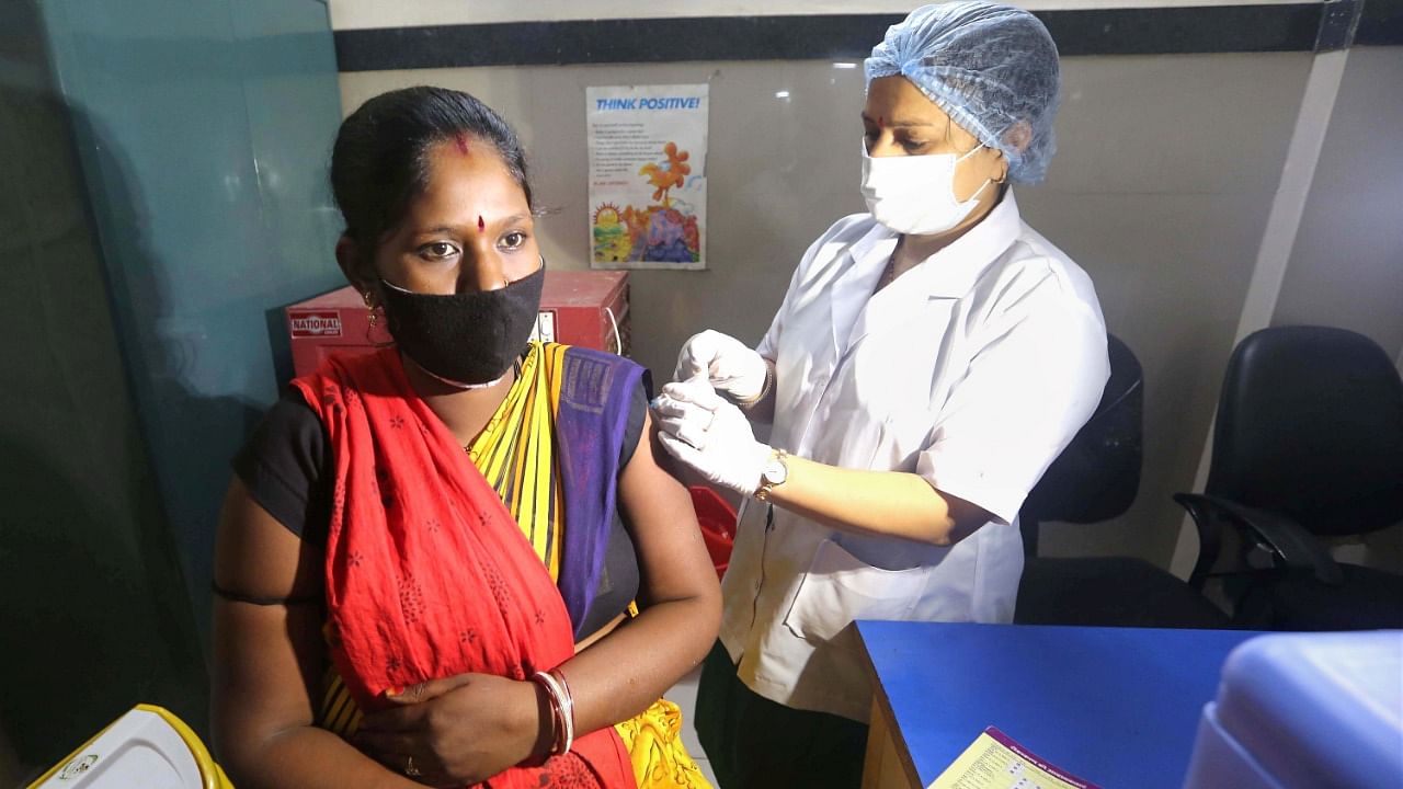 A medic administers a dose of Covid-19 vaccine to a beneficiary during an inoculation drive specially for pregnant women at Government JP hospital in Bhopal. Credit: PTI File Photo