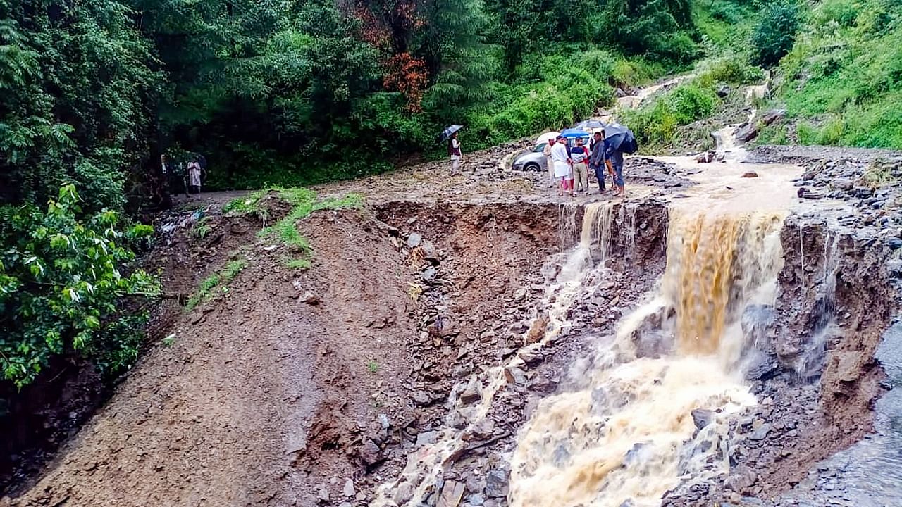 A washed away road following heavy rains, at Kyara Panchayat in Theog near Shimla. Credit: PTI Photo