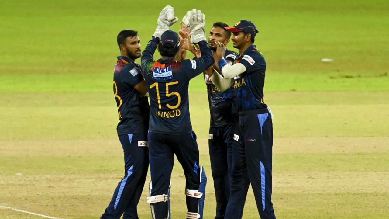 Sri Lanka's cricketers celebrates after the dismissal of India's Rahul Chahar (not pictured) during the third Twenty20 international cricket match between Sri Lanka and India at the R.Premadasa Stadium in Colombo. Credit: AFP Photo