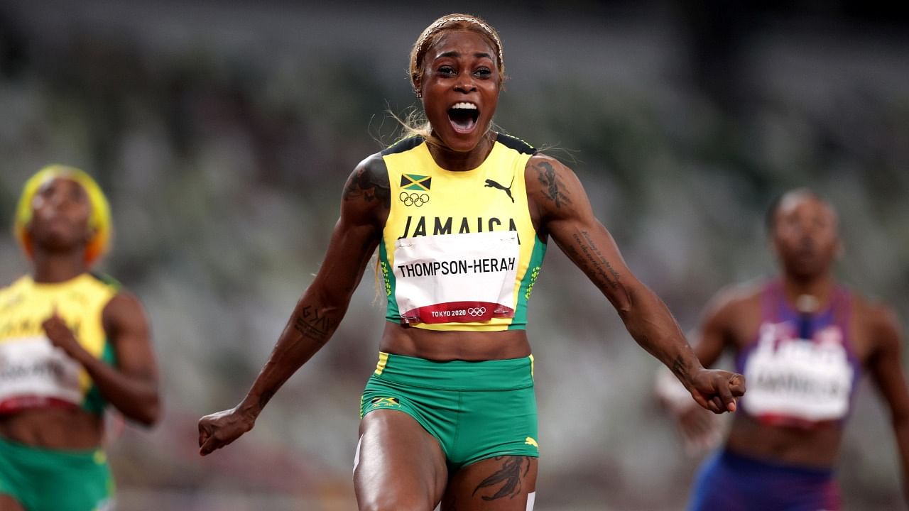 Elaine Thompson-Herah of Jamaica celebrates crossing the finish line to win gold in women's 100m sprint. Credit: Reuters Photo