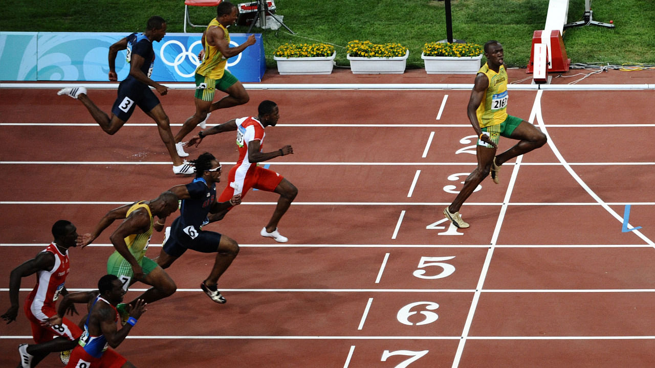 Jamaica's Usain Bolt (R) crossing the finish line to win the men's 100m final at the National stadium as part of the 2008 Beijing Olympic Games. Credit: AFP Photo