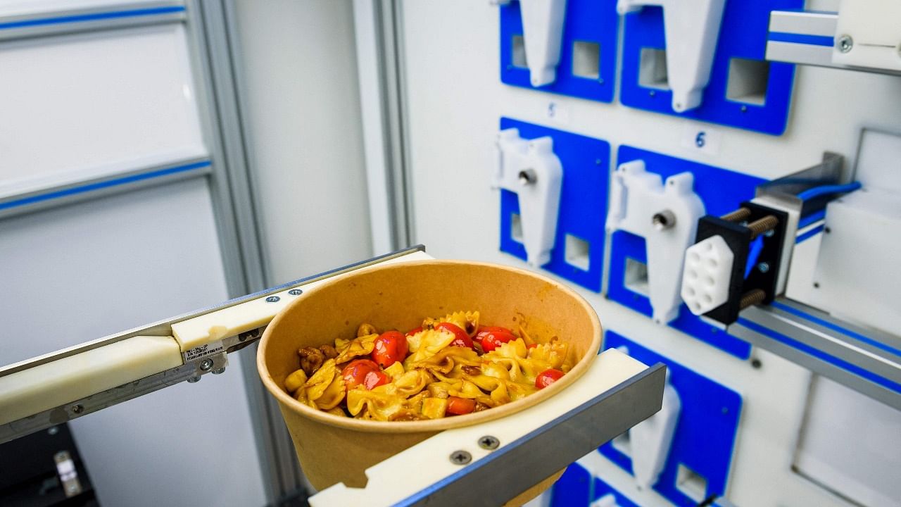 A pasta order comes in and the robotic arm springs into action at the Roboeatz eatery in Riga. Credit: AFP Photo
