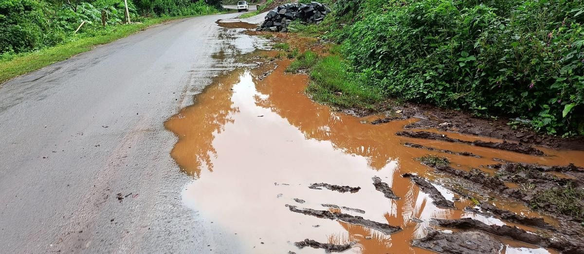 A large puddle has formed beside a road in Hosathota.