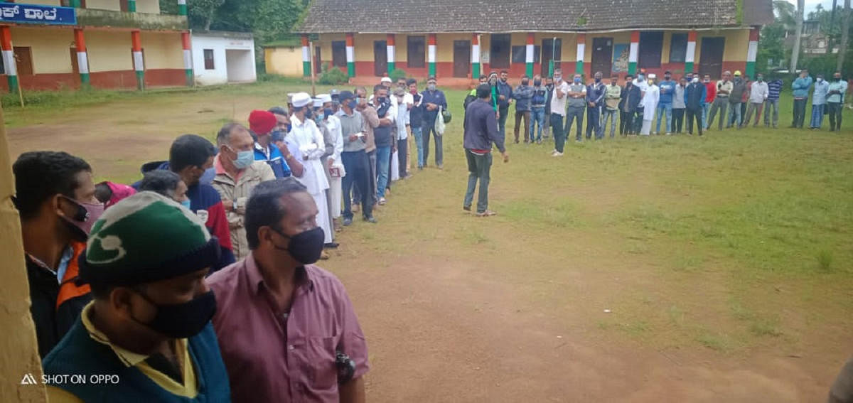 People stand in a queue to get vaccinated in Napoklu.