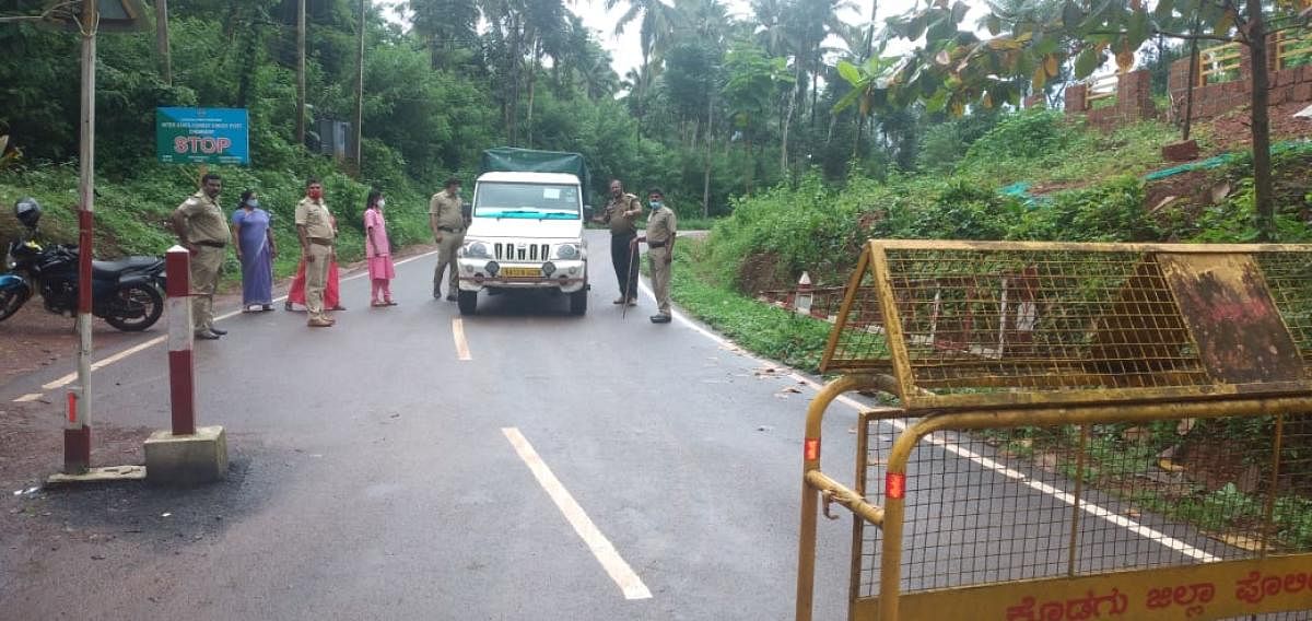 Officials check a vehicle coming from Kerala at Karike check post.
