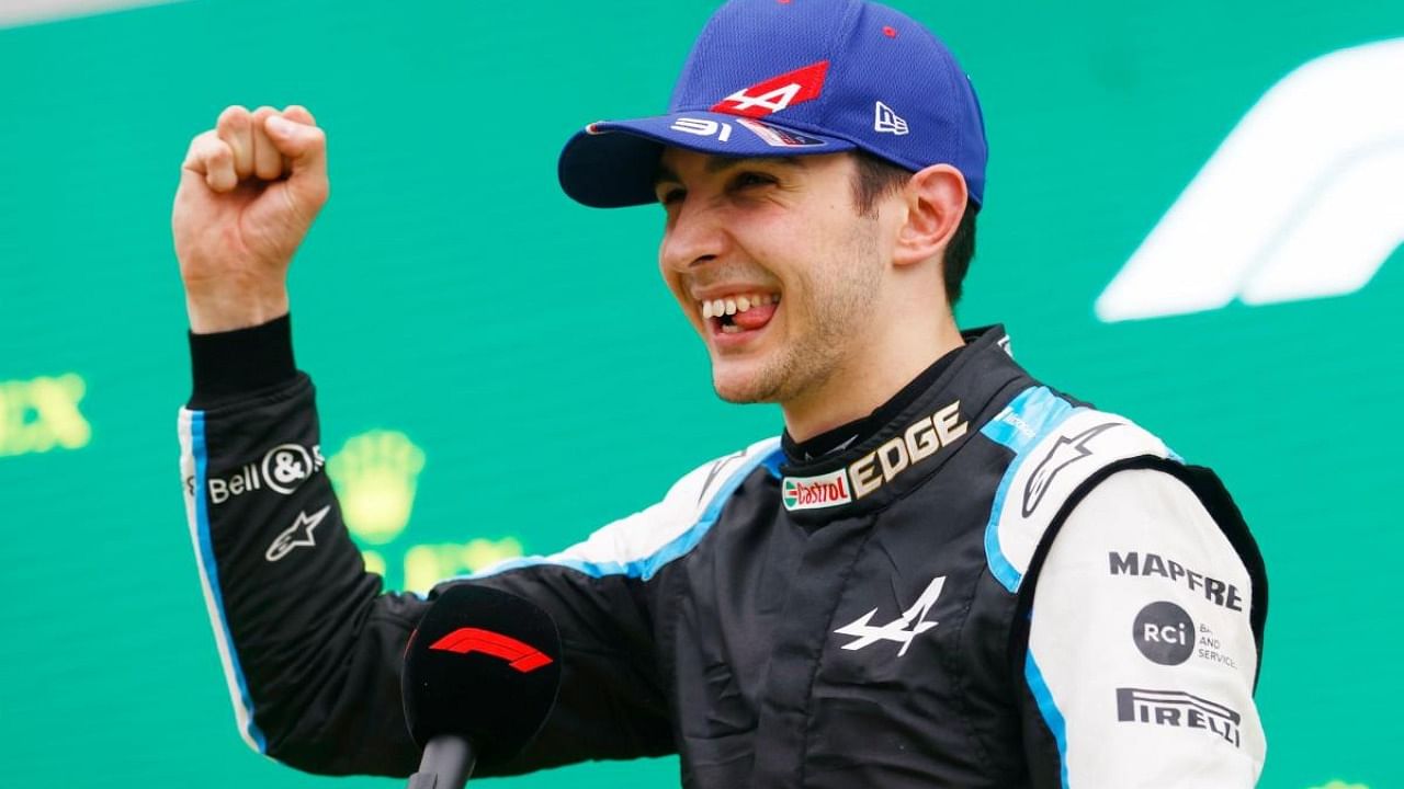 Alpine's Esteban Ocon celebrates on the podium after winning the race. Credit: Reuters Photo