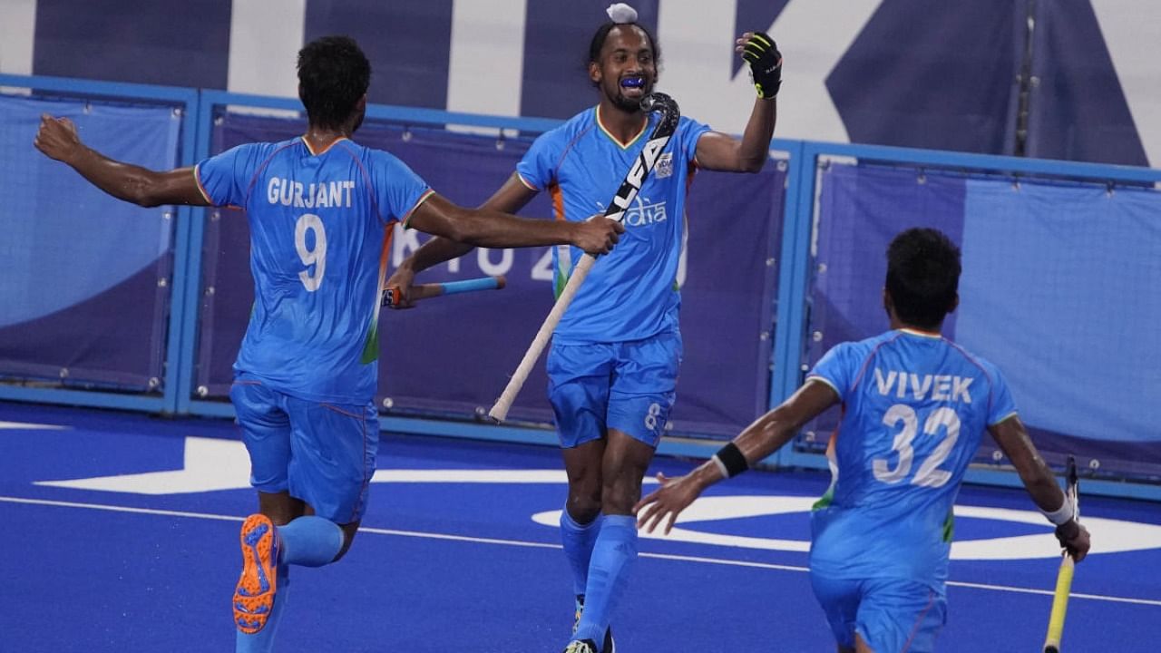 India's Hardik Singh (8) celebrates with his teammates after scoring on Britain goalkeeper Oliver Payne during a men's field hockey match at the 2020 Summer Olympics. Credit: AP Photo