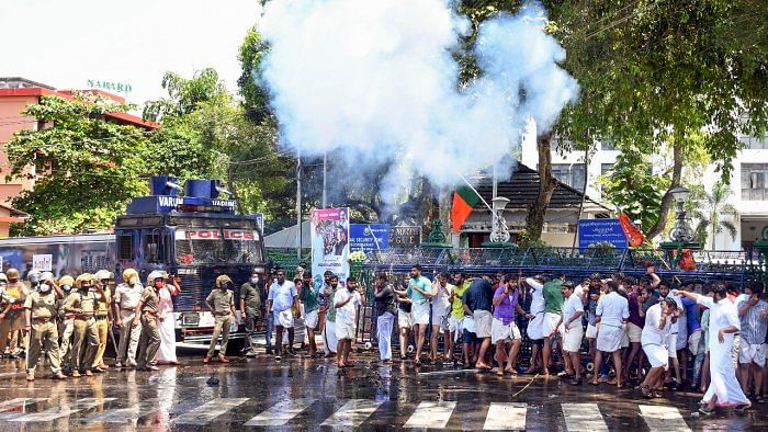Police use tear gas shells to disperse Bharatiya Janata Yuva Morcha (BJYM) activists during a protest over the allegation of 'backdoor' entry into government services, in Thiruvananthapuram. Credit: PTI Photo
