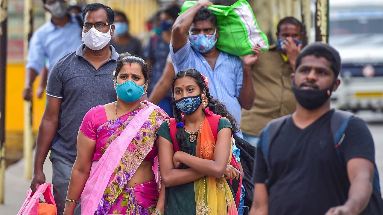 Passengers wear face masks for prevention against Covid-19, at Sangolli Rayanna railway station in Bengaluru, Thursday, July 15, 2021. Credit: PTI Photo