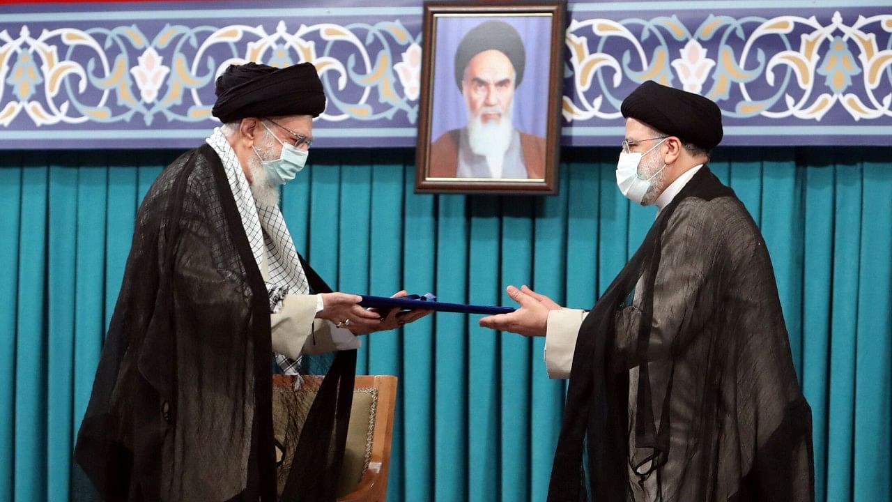 Iran's new President Ebrahim Raisi receives the endorsement decree for his presidency from Iran's Supreme Leader Ayatollah Ali Khamenei. Credit: Reuters Photo