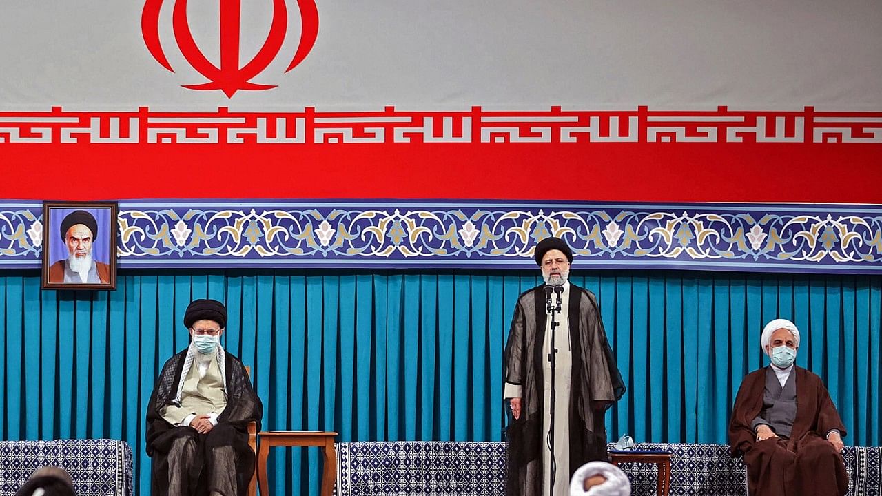  Supreme Leader Ayatollah Ali Khamenei, (C L) flanked by outgoing president Hassan Rouhani (L) during the inauguration ceremony for Ebrahim Raisi (C R) in the presence of the head of judiciary authority Gholamhossein Mohseni-Ejei (R) in Khamenei's office in the capital Tehran. Credit: AFP Photo