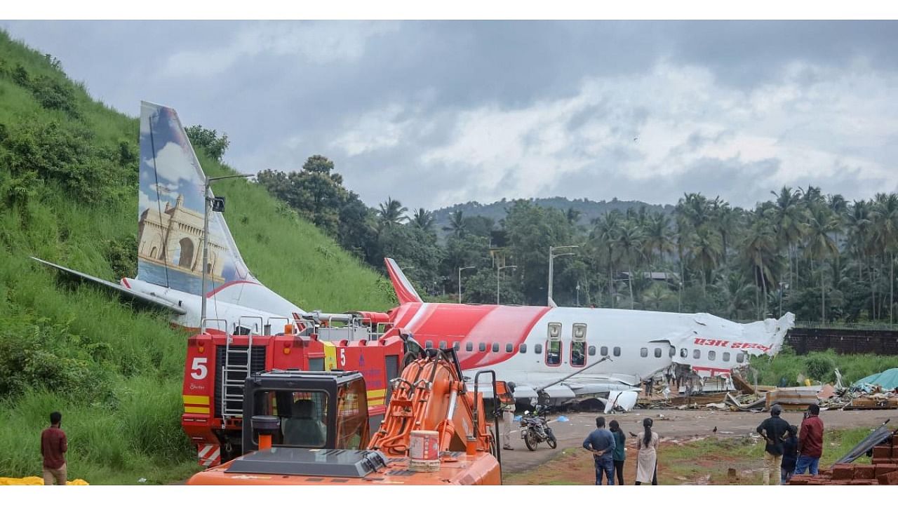 Mangled remains of an Air India Express flight, en route from Dubai, after it skidded off the runway while landing on Friday night, at Karippur in Kozhikode. Credit: PTI file photo