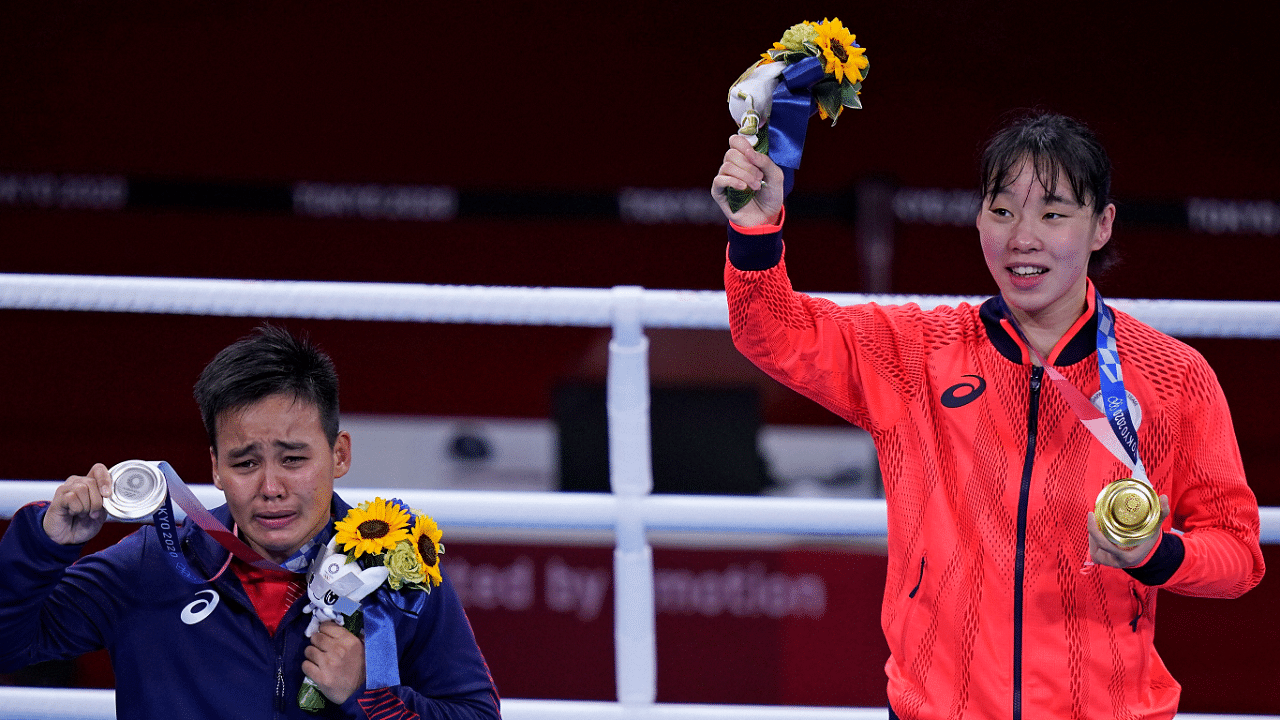 Japan's Sena Irie, right, holds her gold medal after defeating the Philippines's Nesthy Petecio, left, in the women's featherweight 60-kg final boxing match. Credit: AP Photo
