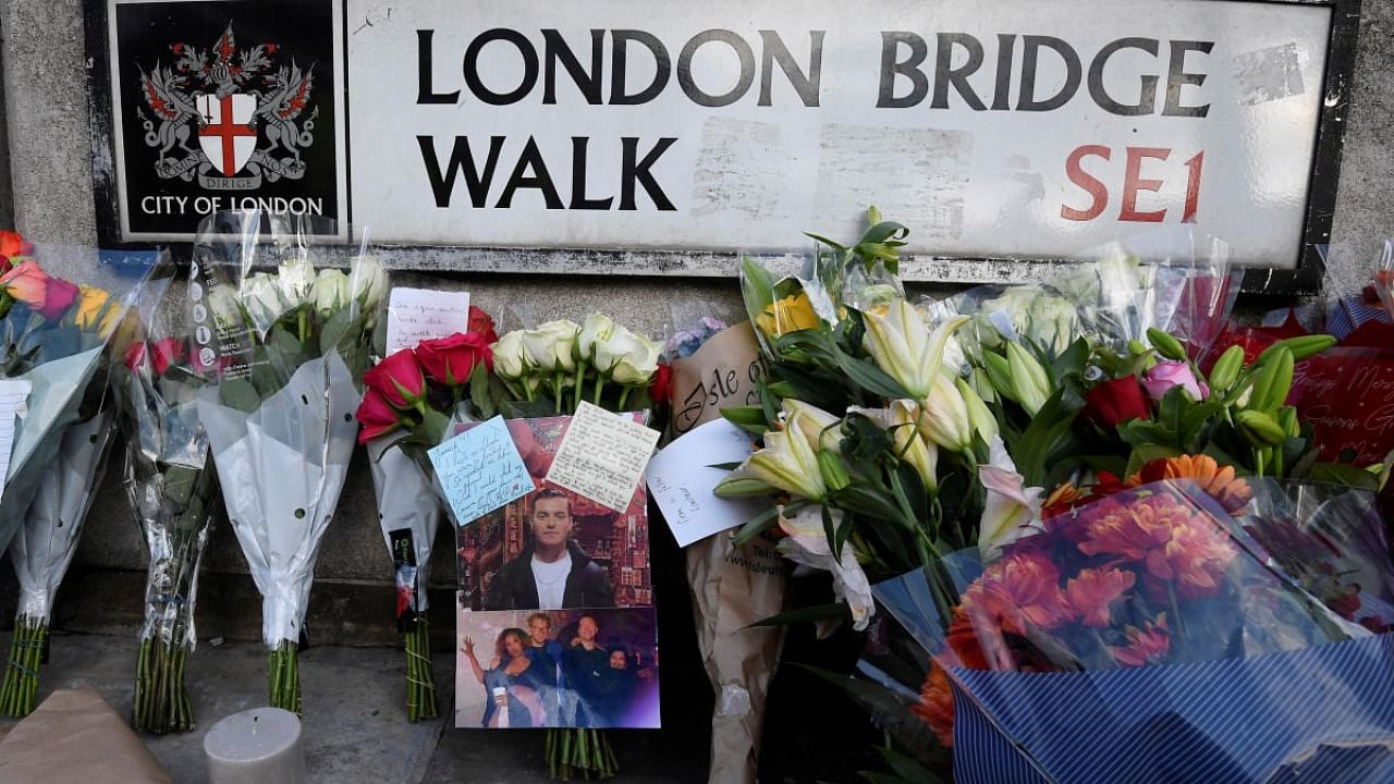 Messages of condolence and floral tributes are seen near the scene of a stabbing on London Bridge, in London. Credit: Reuters photo