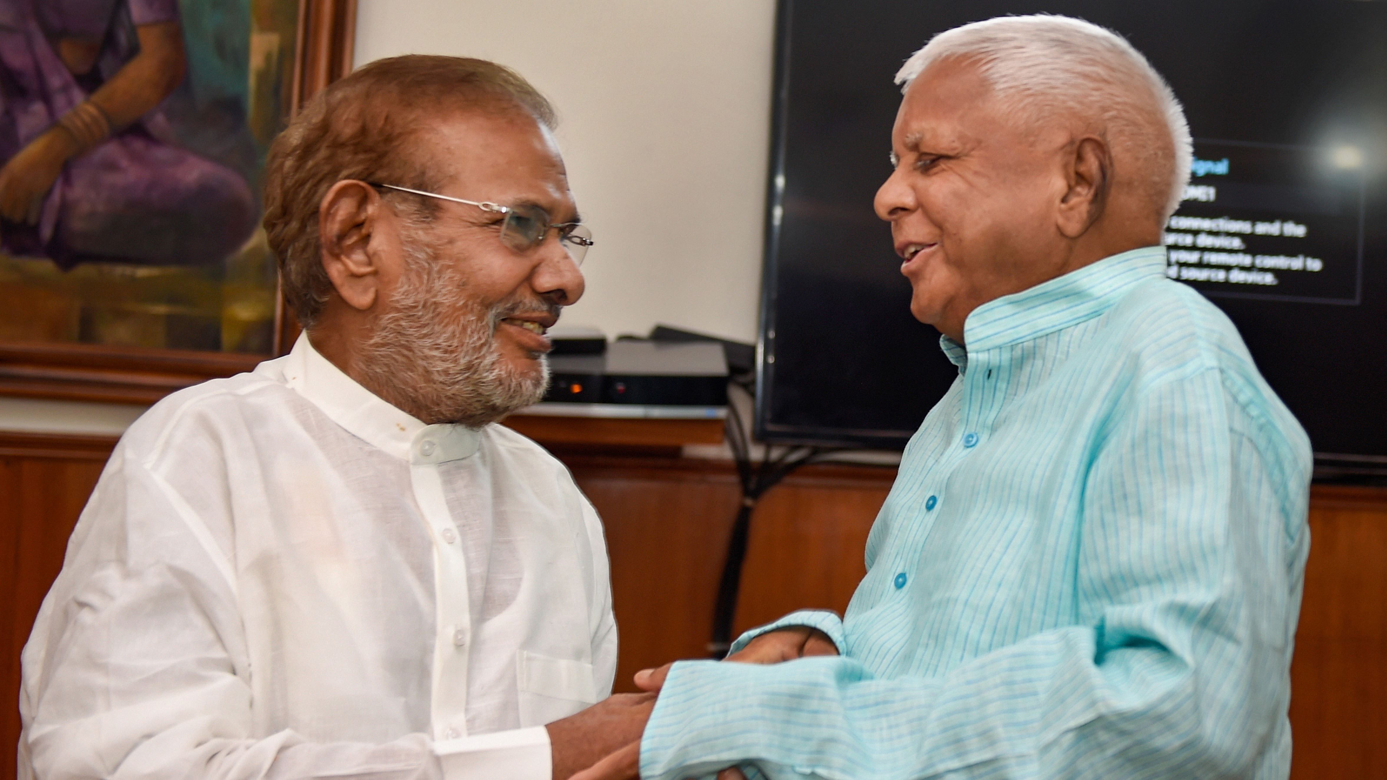 Rashtriya Janata Dal supremo Lalu Prasad Yadav meets former JD(U) leader Sharad Yadav in New Delhi. Credit: PTI File Photo