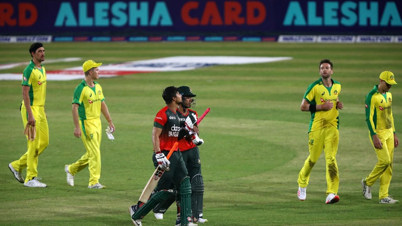  Bangladesh's Afif Hossain and Nurul Hasan walk past Australia's players after winning their match. Credit: Reuters Photo