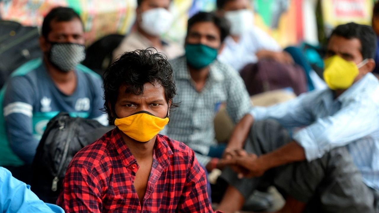 Stranded migrant workers wait to board a special train to Bihar state from MGR central railway station after the government eased a nationwide lockdown imposed as a preventive measure against the Covid-19 coronavirus, in Chennai on June 18, 2020. Credit: AFP File Photo