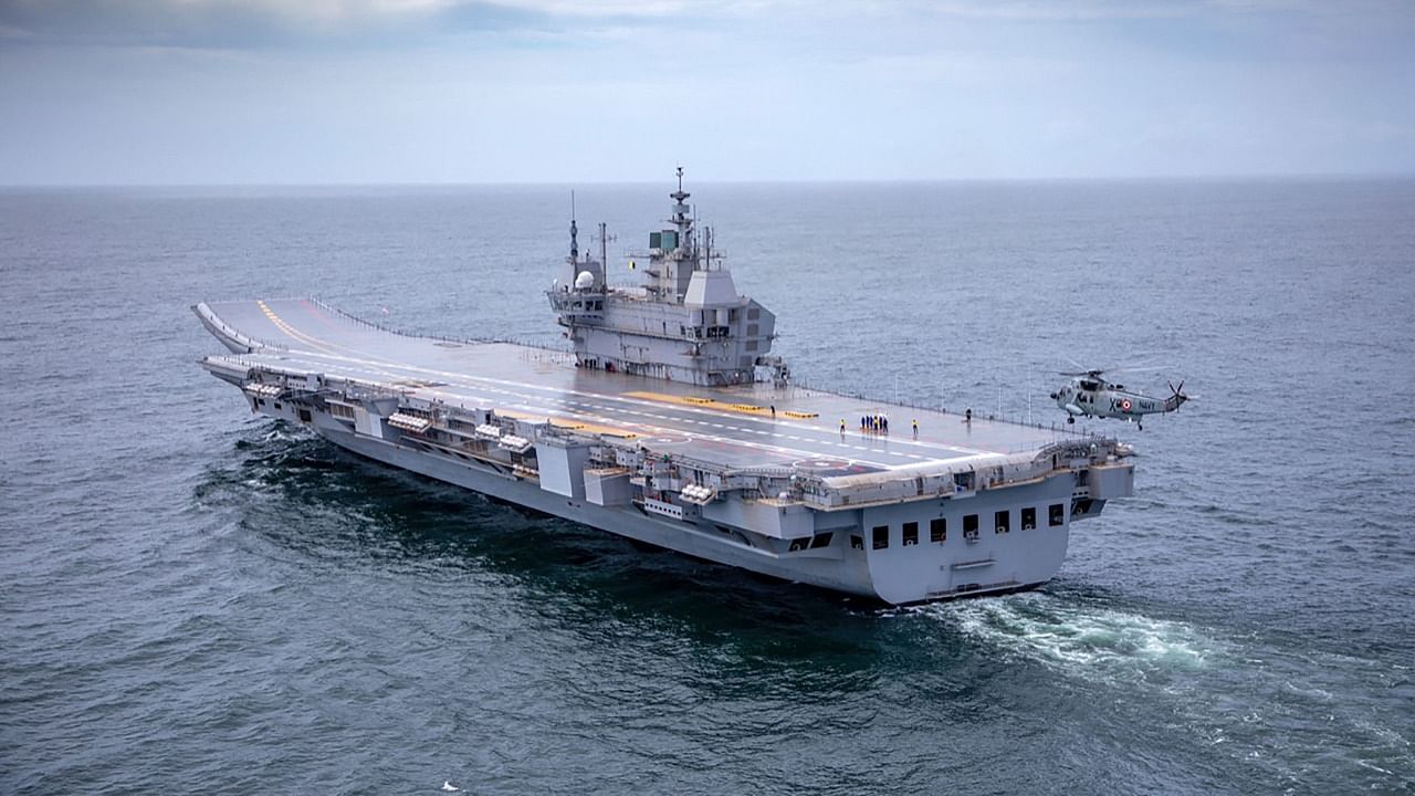In this handout photo taken on August 4, 2021 and released by the Indian Navy, the Indigenous Aircraft Carrier (IAC P71) 'Vikrant' sets out as it commenced its sea trials from the naval dockyard in Kochi. Credit: AFP Photo/Indian Navy