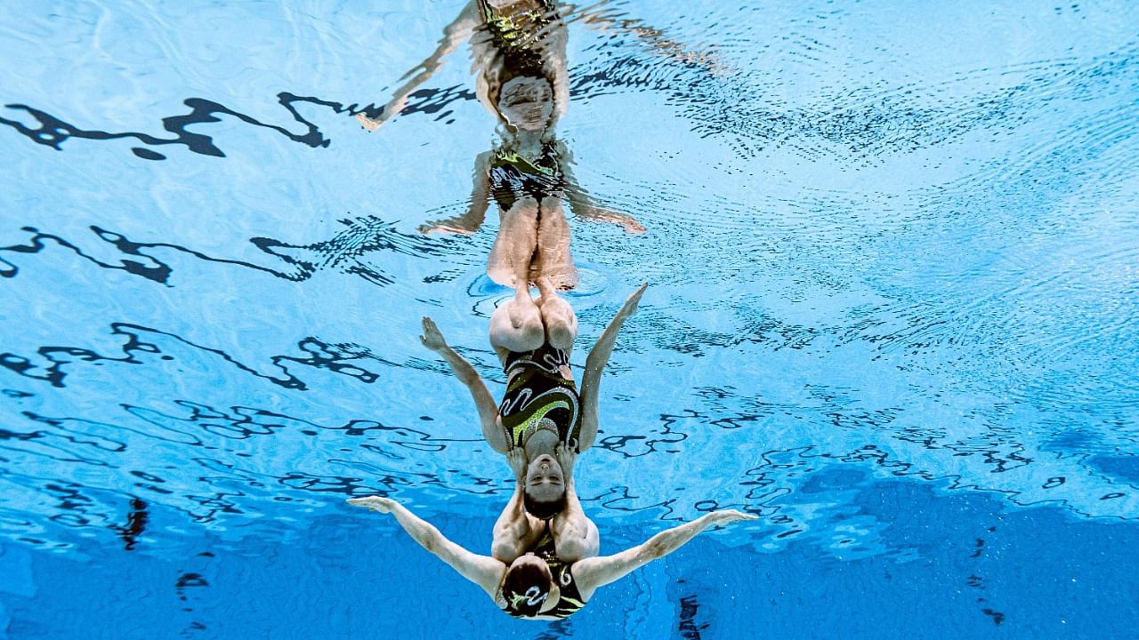 The final of the women's duet free routine artistic swimming event. Credit: AFP Photo