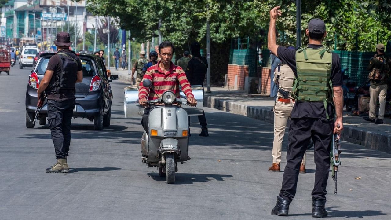 Indian security personnel stand guard along the street on the occasion of the second anniversary of New Delhi imposing direct rule ending the region's partial autonomy in Srinagar. Credit: AFP Photo