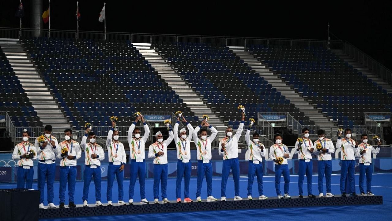 India's bronze medallists pose on the podium during the medal ceremony of the Tokyo 2020 Olympic Games men's field hockey competition, at the Oi Hockey Stadium in Tokyo. Credit: AFP Photo