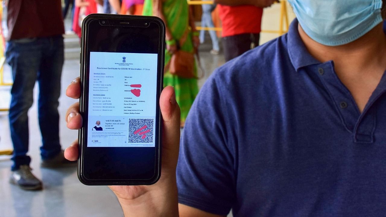 A Covid-19 vaccine beneficiary shows his vaccination certificate on his mobile phone. Credit: PTI File Photo