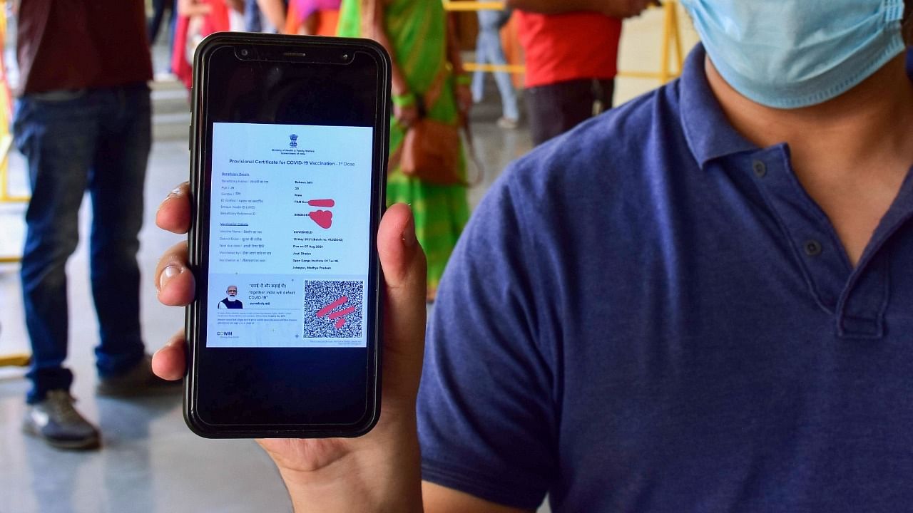 <div class="paragraphs"><p>A Covid-19 vaccine beneficiary shows his vaccination certificate on his mobile phone. </p></div>