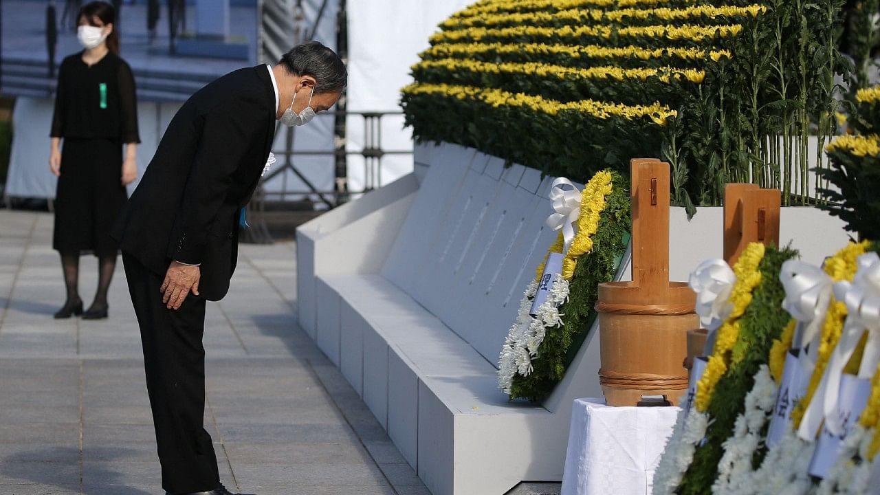 Japan's Prime Minister Yoshihide Suga pays his respects during a ceremony to mark the 76th anniversary of the world's first atomic bomb attack at the Peace Memorial Park in Hiroshima. Credit: AFP Photo