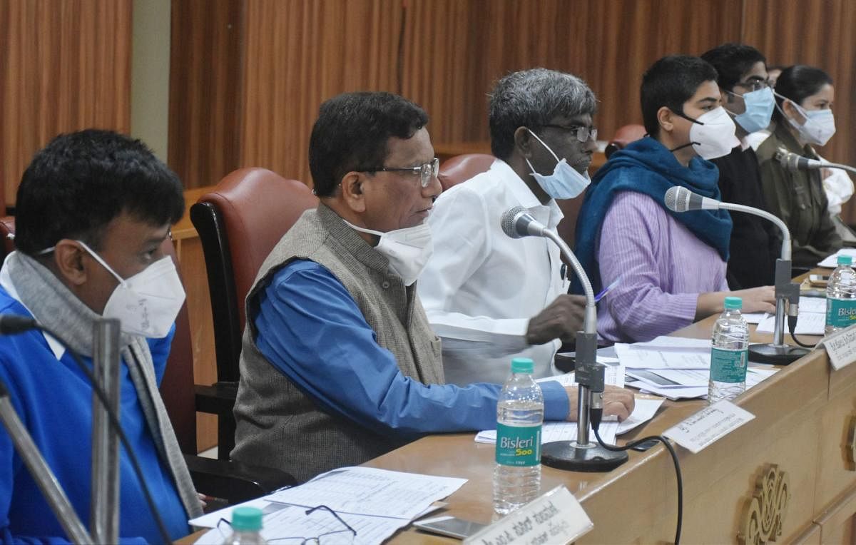District In-charge Minister Kota Srinivas Poojary chairs a progress review meeting at the Zilla Panchayat auditorium in Madikeri on Friday.