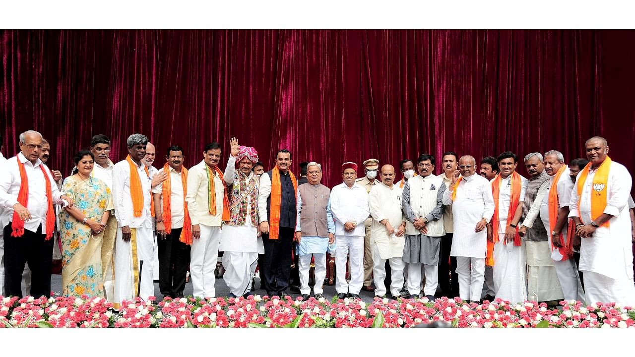 Karnataka Governor Thawar Chand Gehlot and Chief Minister Basavaraj Bommai with newly inducted ministers during swearing-in ceremony. Credit: PTI Photo