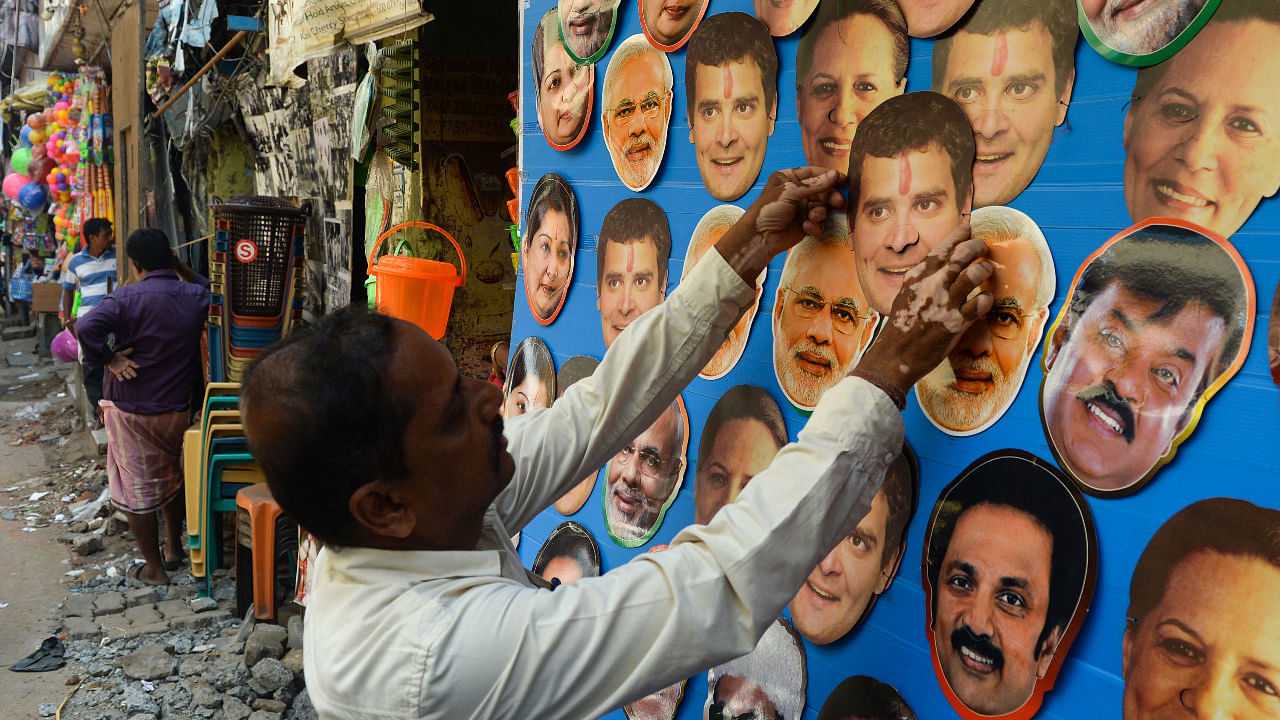 A shopkeeper displays masks of Indian Congress Party President Rahul Gandhi and Indian Prime Minister Narendra Modi for sale at a roadside shop in Chennai. Credit: AFP Photo