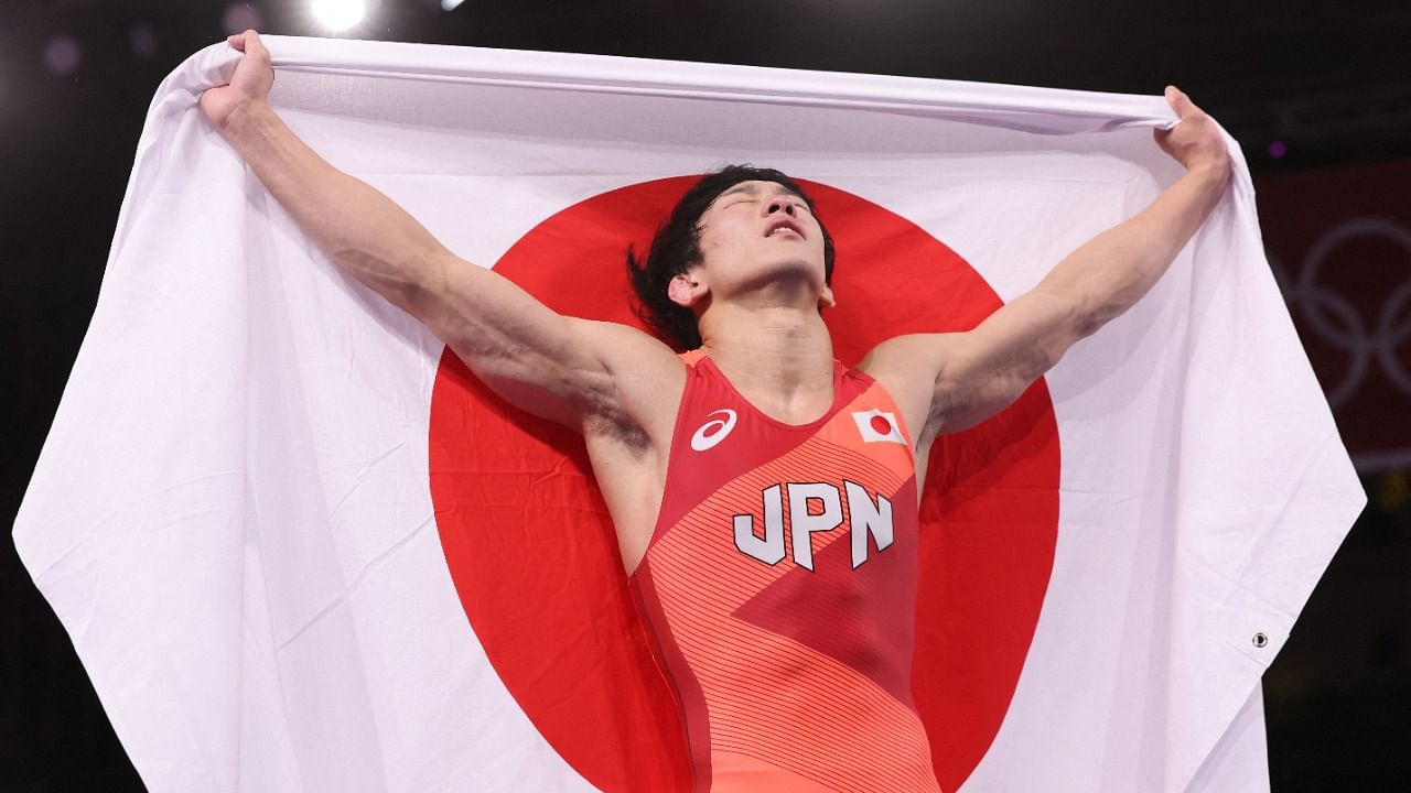  Japan's Takuto Otoguro celebrates his gold medal victory against Azerbaijan's Haji Aliyev. Credit: AFP Photo