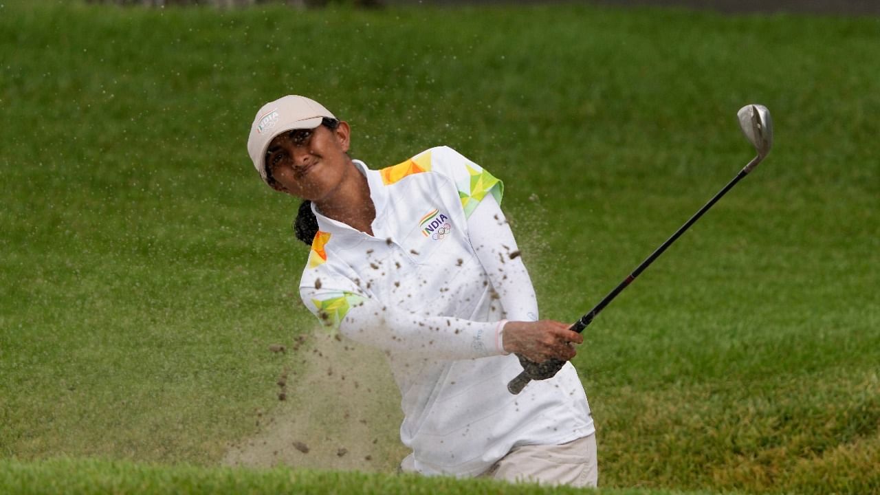 Ashok plays a shot from a bunker on the 7th hole. Credit: AP Photo