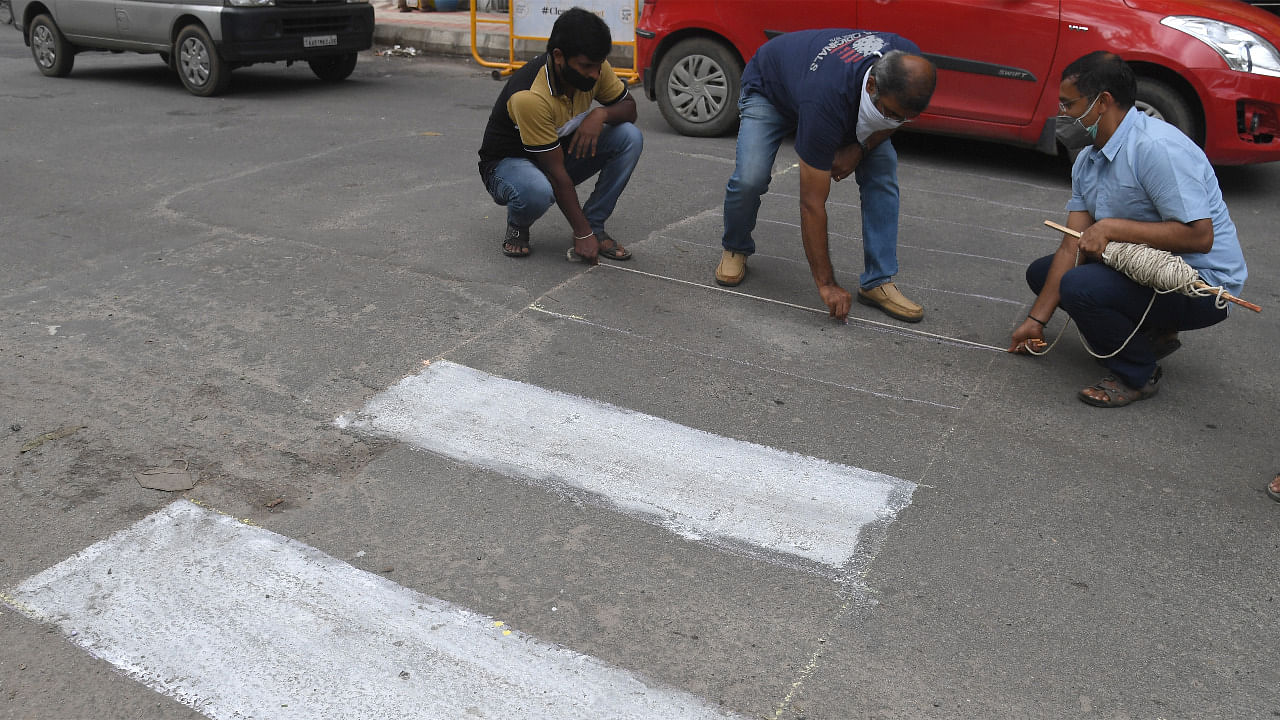 Residents lay down markings to make road pedestrian friendly. Credit: DH Photo/S K Dinesh