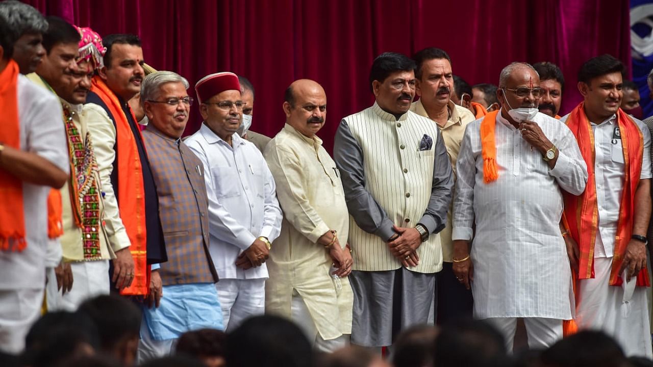 Karnataka Governor Thawar Chand Gehlot and Chief Minister Basavaraj Bommai with newly inducted ministers during swearing-in ceremony to form the Cabinet at Raj Bhavan in Bengaluru. Credit: PTI Photo