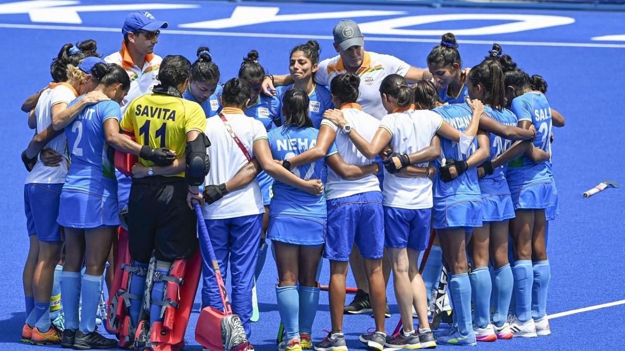 Indian players huddle after losing their women's field hockey bronze medal match against Great Britain, at the 2020 Summer Olympics, in Tokyo. Credit: PTI Photo