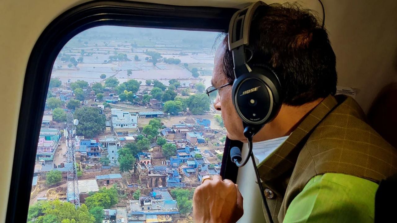 Madhya Pradesh Chief Minister Shivraj Singh Chouhan conducts aerial survey of flood-affected areas of the state, in Datia district, Wednesday. Credit: PTI Photo