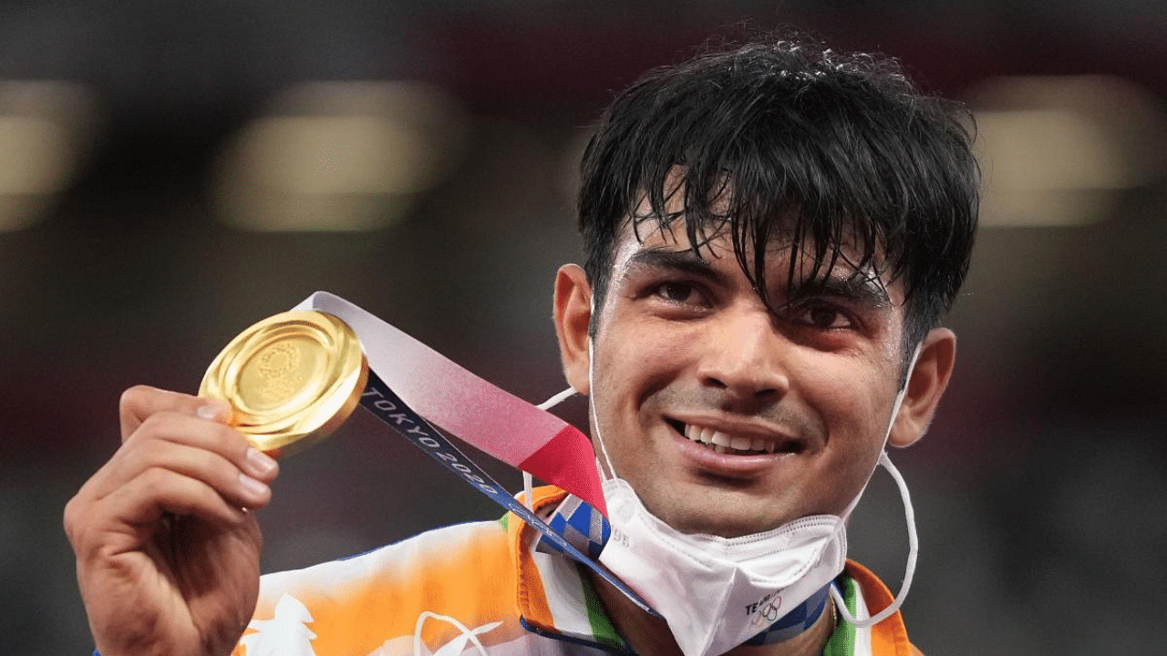 India's Neeraj Chopra holds the gold medal after winning in the final of the men's javelin throw event at the 2020 Summer Olympics. Credit: PTI Photo